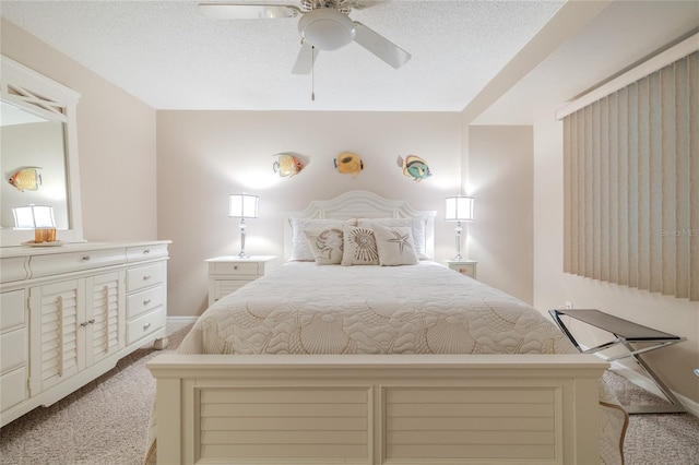 carpeted bedroom featuring ceiling fan and a textured ceiling