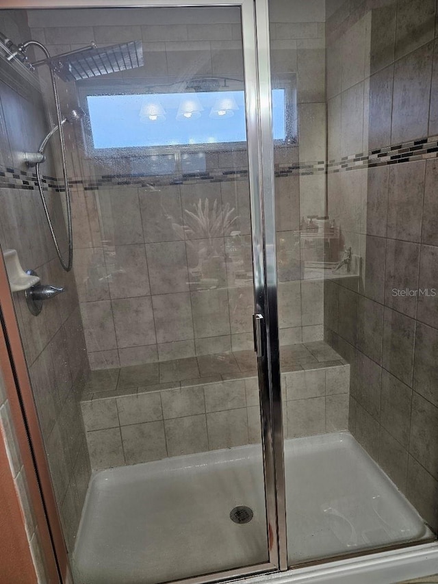 bathroom with a shower with shower door