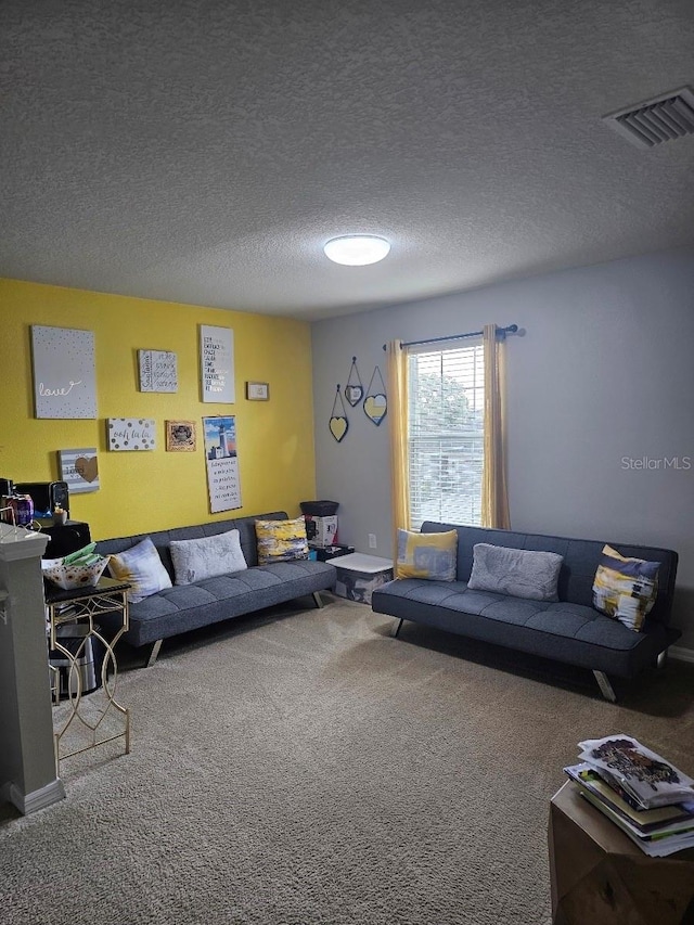 living room featuring carpet and a textured ceiling