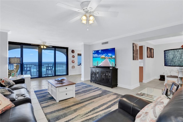 living room with ceiling fan, light tile patterned flooring, a wall of windows, and crown molding