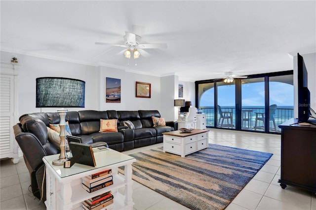 tiled living room featuring expansive windows, ornamental molding, and ceiling fan