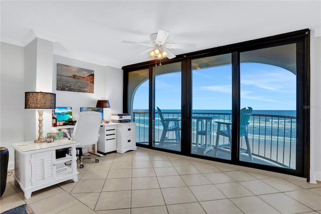 tiled home office featuring ceiling fan, a water view, and ornamental molding