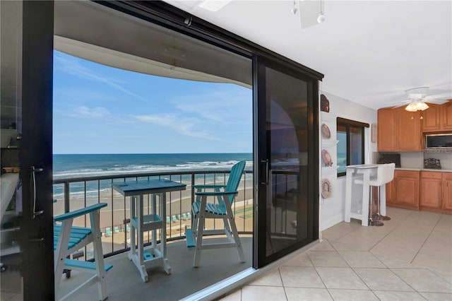 balcony with a water view and a beach view