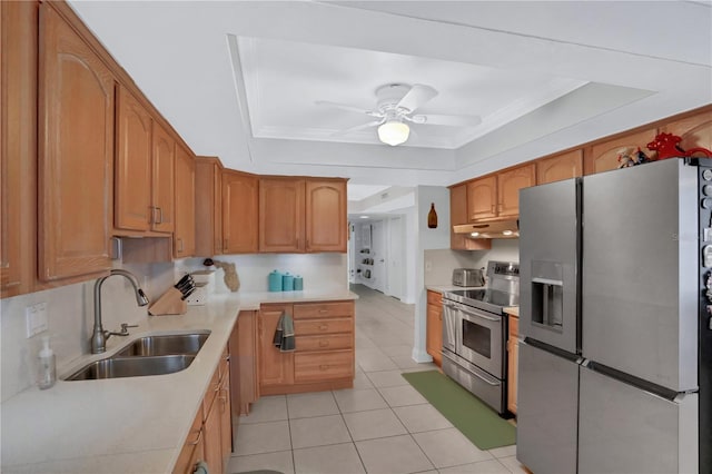 kitchen featuring ceiling fan, sink, stainless steel appliances, a raised ceiling, and light tile patterned flooring