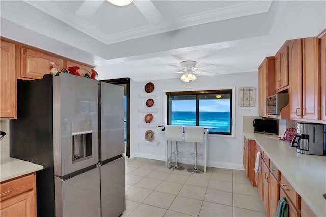 kitchen with stainless steel fridge, light tile patterned floors, ornamental molding, and ceiling fan