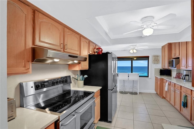 kitchen with ceiling fan, light tile patterned floors, ornamental molding, and appliances with stainless steel finishes