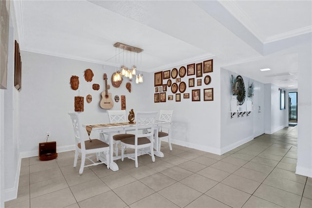 dining room featuring crown molding, light tile patterned floors, and a chandelier