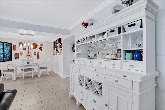 bar featuring crown molding, light tile patterned flooring, and decorative light fixtures