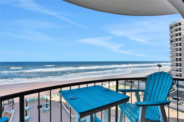 balcony featuring a water view and a beach view