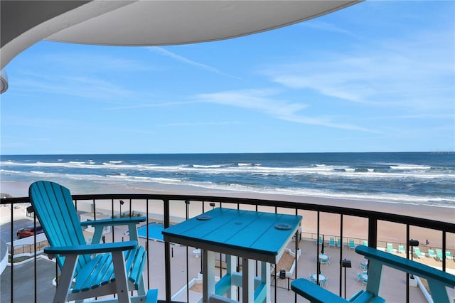 balcony with a water view and a beach view