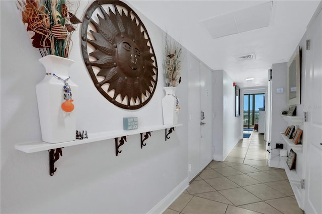 corridor with light tile patterned flooring