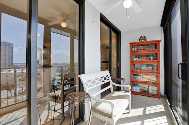 sunroom / solarium with ceiling fan and a healthy amount of sunlight