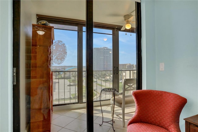 entryway featuring ceiling fan, floor to ceiling windows, and light tile patterned floors