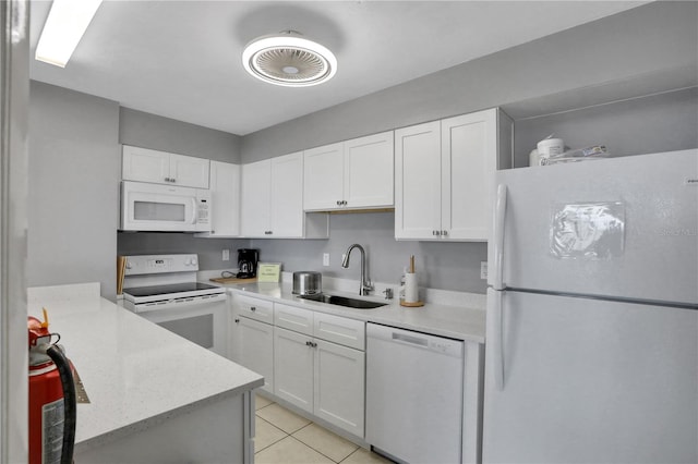 kitchen with white cabinetry, white appliances, sink, and light tile patterned floors