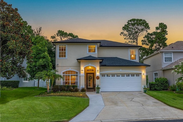 view of front of home with a lawn and a garage