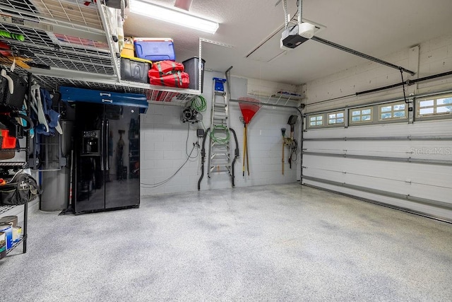 garage with black fridge and a garage door opener