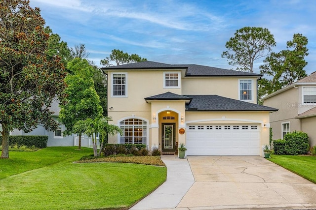 view of front of house with a garage and a front lawn