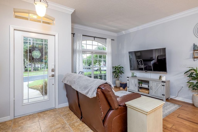 living room with crown molding, a textured ceiling, and light wood-type flooring