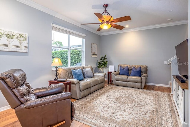 living room with ceiling fan, wood-type flooring, and ornamental molding