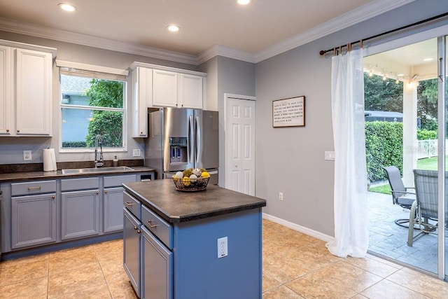 kitchen with white cabinetry, sink, a kitchen island, and stainless steel refrigerator with ice dispenser