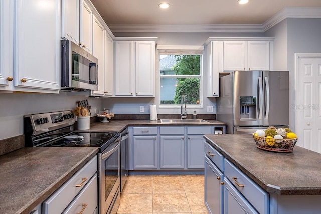 kitchen featuring sink, light tile patterned floors, appliances with stainless steel finishes, white cabinets, and ornamental molding