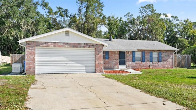 ranch-style home with ac unit, a garage, and a front lawn