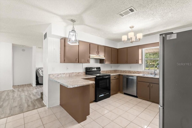 kitchen featuring pendant lighting, an inviting chandelier, sink, appliances with stainless steel finishes, and kitchen peninsula