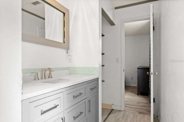 bathroom with hardwood / wood-style floors and vanity