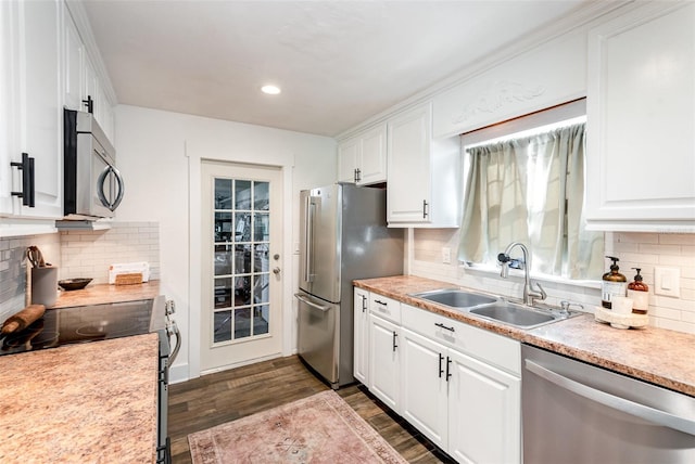 kitchen with tasteful backsplash, stainless steel appliances, sink, dark hardwood / wood-style floors, and white cabinetry