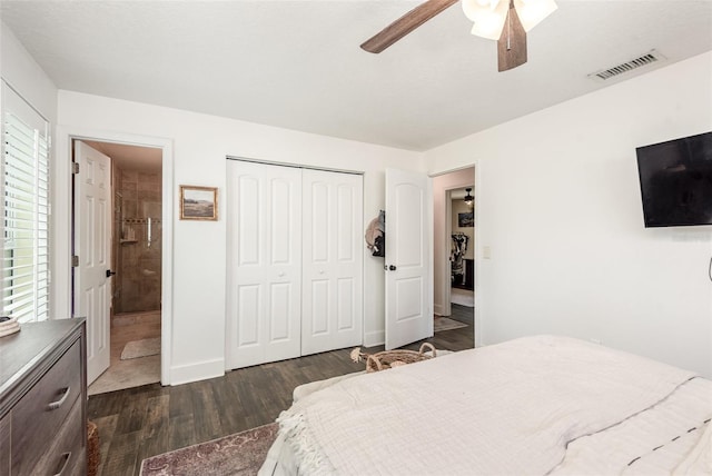 bedroom with dark hardwood / wood-style floors, ceiling fan, ensuite bath, and a closet