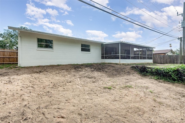 rear view of property with a sunroom