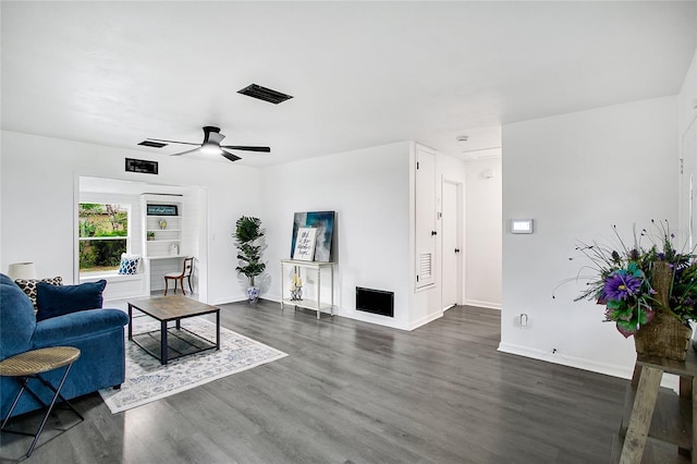 living room with dark hardwood / wood-style floors and ceiling fan