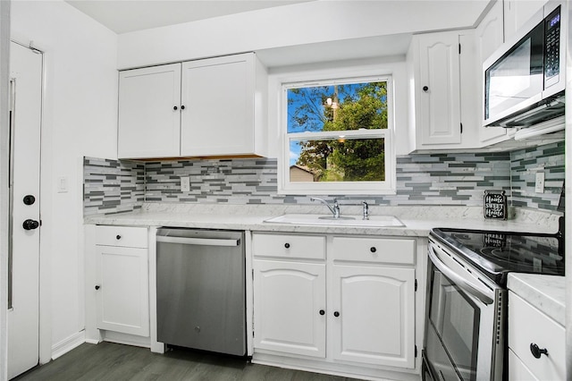 kitchen featuring white cabinetry, sink, dark wood-type flooring, and appliances with stainless steel finishes