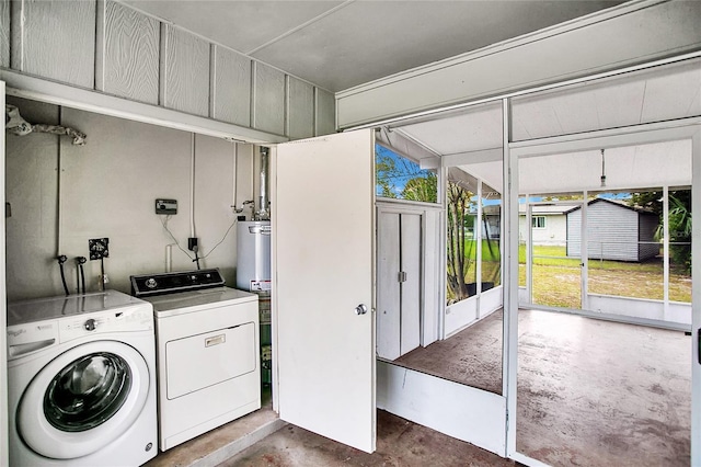 laundry area with gas water heater and separate washer and dryer