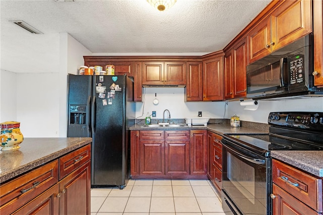 kitchen with sink, light tile patterned flooring, black appliances, and a textured ceiling