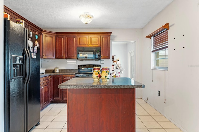 kitchen with black appliances, a kitchen island, and light tile patterned flooring