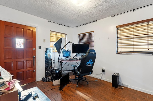 home office with hardwood / wood-style flooring and a textured ceiling