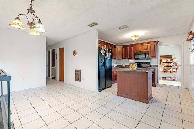 kitchen featuring pendant lighting, black appliances, a textured ceiling, a notable chandelier, and a kitchen island