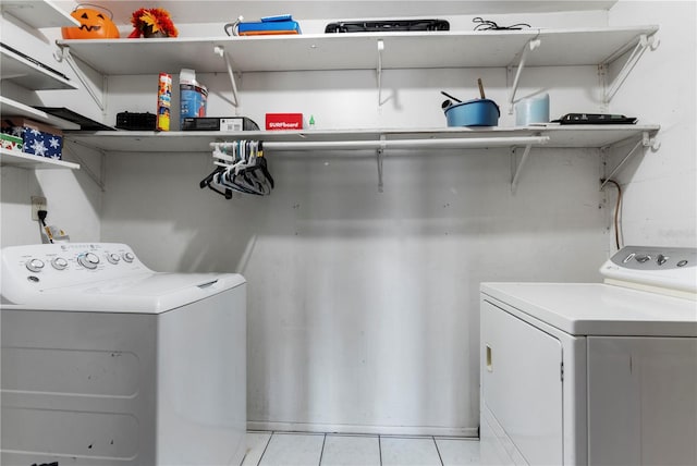 washroom featuring washer and dryer and light tile patterned floors