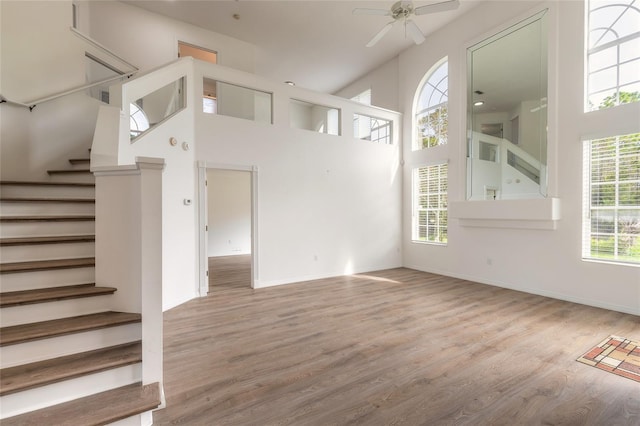 unfurnished living room featuring plenty of natural light, light hardwood / wood-style floors, and ceiling fan