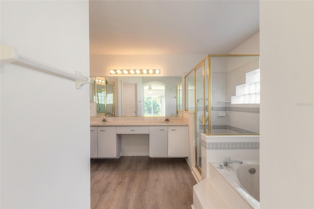 bathroom with shower with separate bathtub, vanity, and hardwood / wood-style flooring