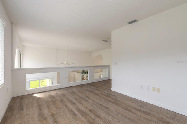 empty room with ceiling fan and wood-type flooring