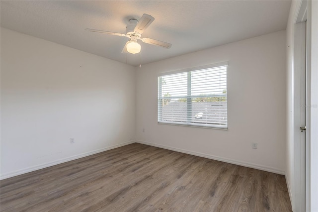 spare room featuring wood-type flooring, a textured ceiling, and ceiling fan