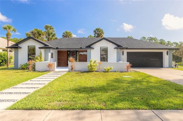 view of front of home with a front yard and a garage