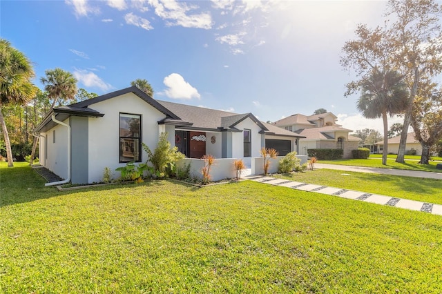 view of front of property with a front lawn and a garage