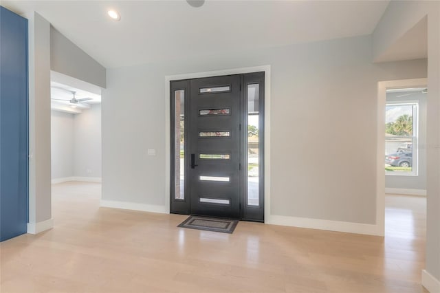 entrance foyer with light hardwood / wood-style floors, vaulted ceiling, and ceiling fan