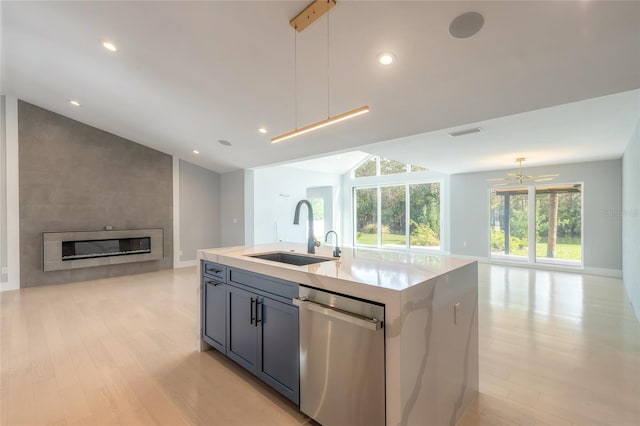 kitchen featuring stainless steel dishwasher, sink, pendant lighting, a center island with sink, and light hardwood / wood-style floors