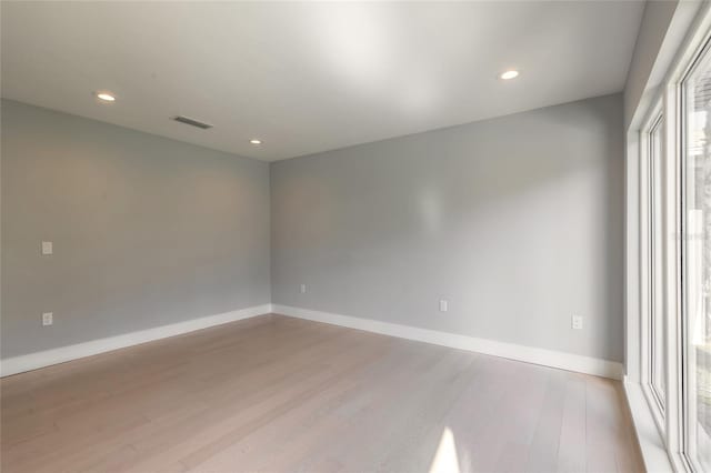 spare room featuring light hardwood / wood-style floors