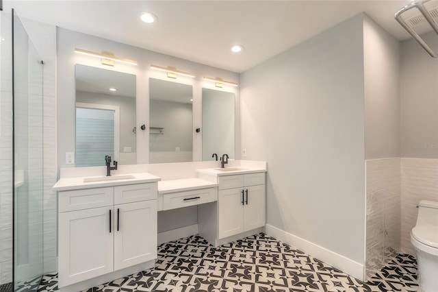 bathroom with tile patterned flooring, vanity, and toilet