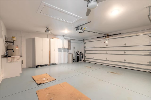 garage with ceiling fan, a garage door opener, and water heater